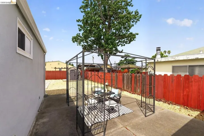 Concrete patio area featuring a metal gazebo structure