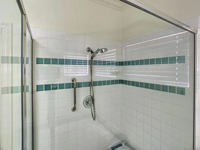 Separate glass shower enclosure.