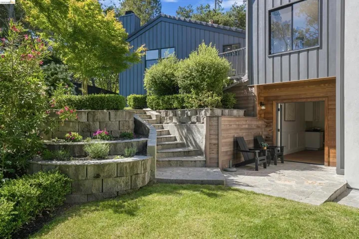 Terraced landscaping featuring stone retaining walls and mature plantings