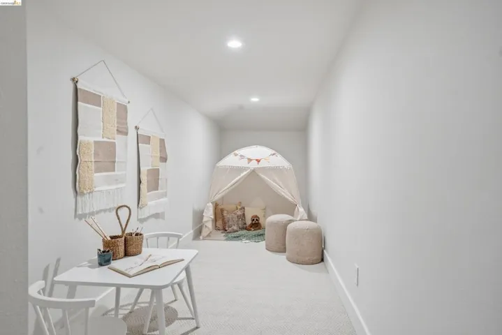 Carpeted room with recessed lighting and neutral wall finishes