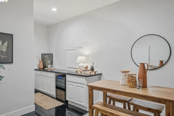 Built-in cabinetry with dark countertops and an integrated beverage cooler
