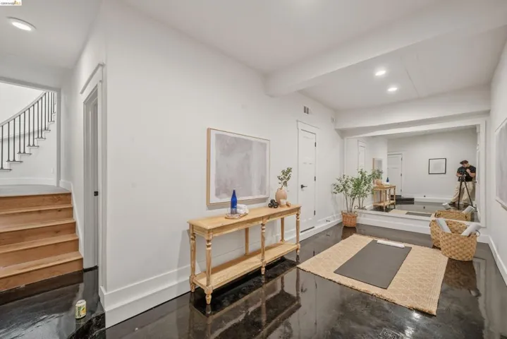 Spacious room with dark, polished flooring and recessed lighting