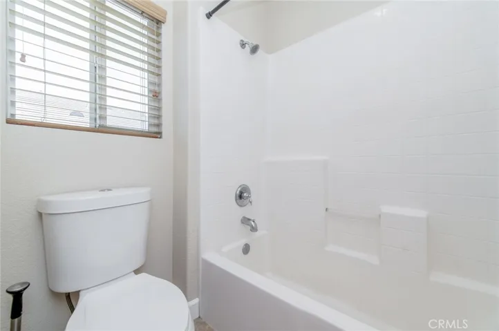 The 2nd bathroom with dual sinks and a shower-over-tub
