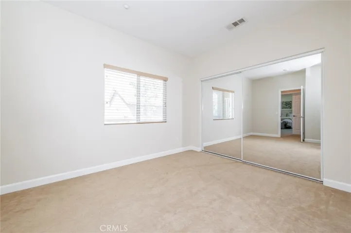 Spacious 3rd bedroom with mirrored closet & storage space