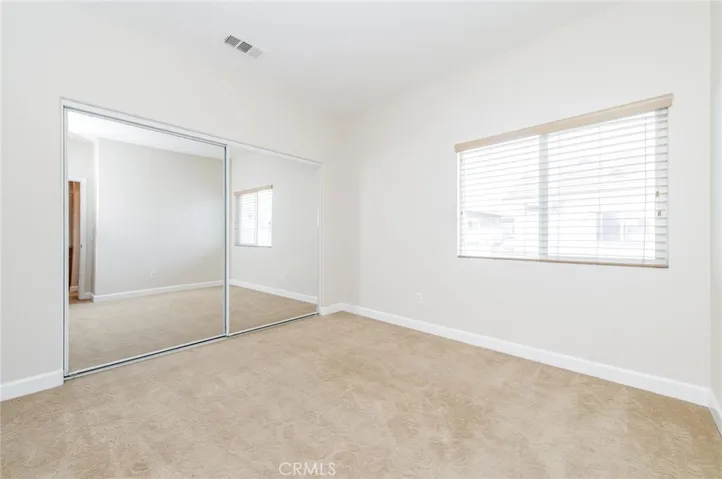 Spacious 2nd bedroom with mirrored closet & storage space