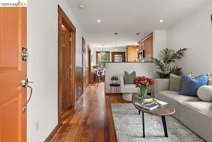Entryway leading to a living area featuring wood-finish flooring