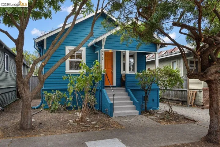 Vibrant blue exterior with white trim and an orange front door