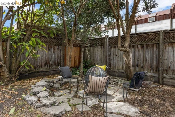 Private backyard featuring a stone patio and mature trees