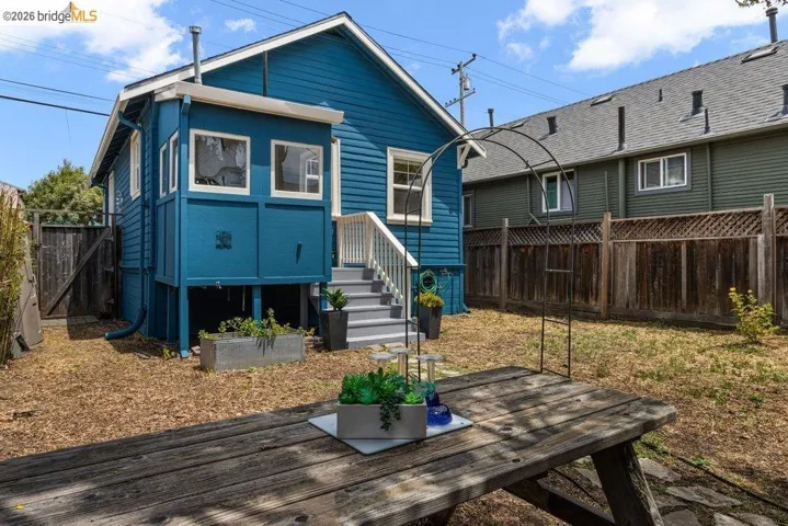 Rear exterior with blue horizontal siding and white trim