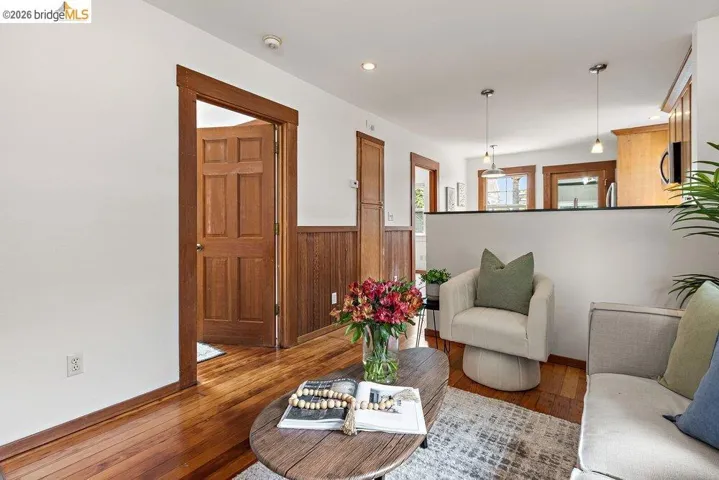 Interior featuring hardwood flooring, white walls, and rich wood trim
