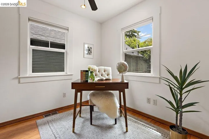Bright interior space featuring wood-finish flooring and white baseboards