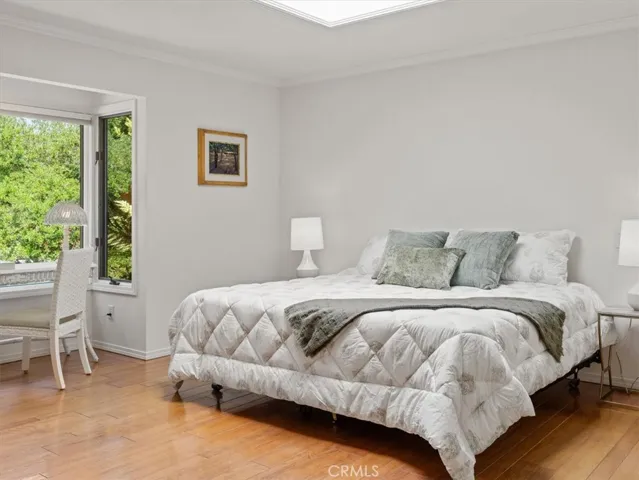 Primary Bedroom is light and bright with a large skylight and picture windows.