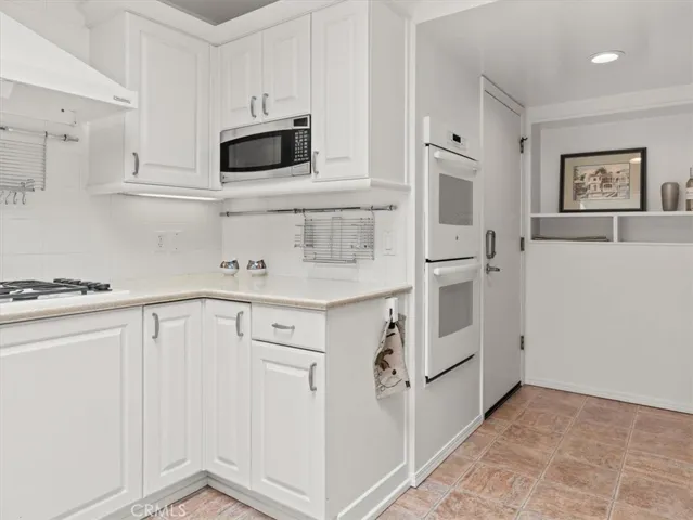 The home has double ovens, and a separate gas cooktop.