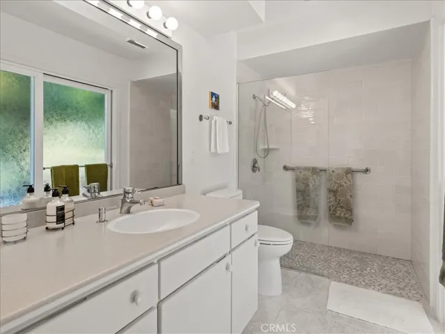 Primary bathroom has a sliding glass door to the backyard.