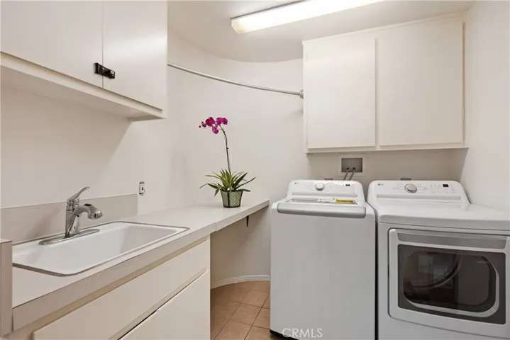 Dedicated laundry room with another tall verticle storage