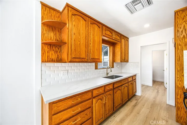 Brand new quartz countertops, backsplash, sink faucet, and new recessed lighting.