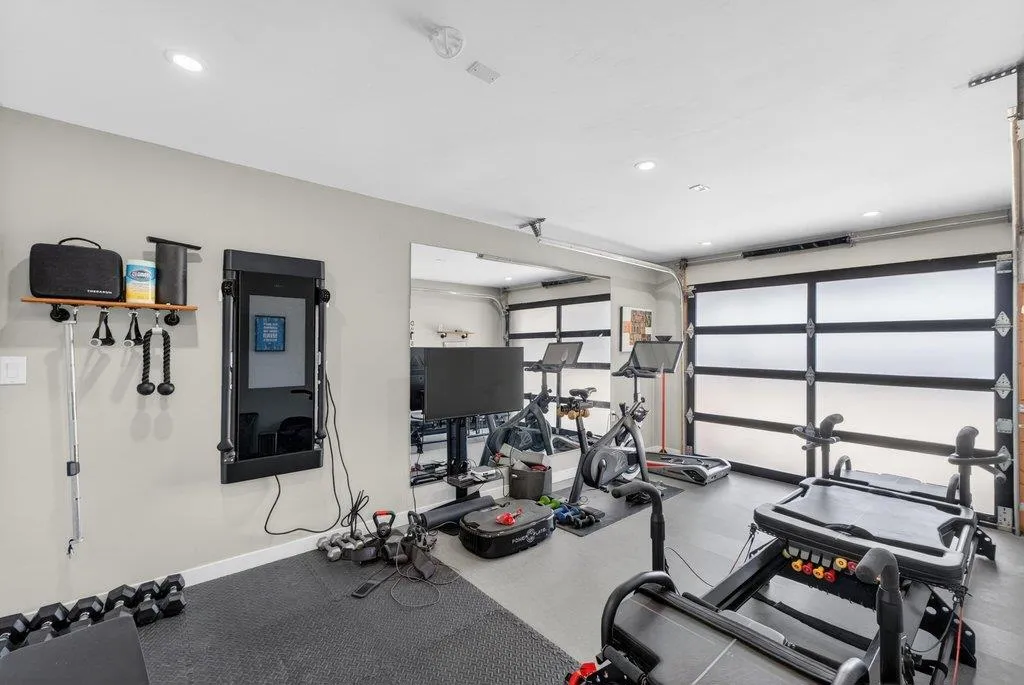 Large gym with roll up door which accesses the rear yard. Awesome feature.