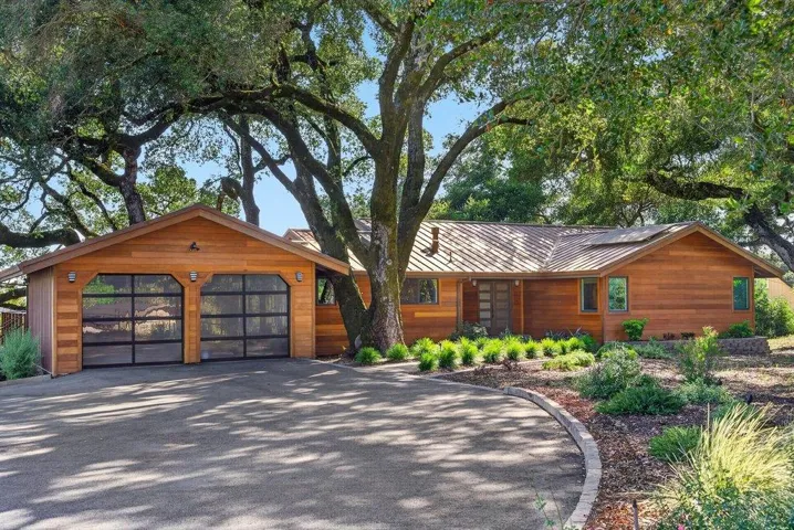 Beautiful Oak Trees and Gorgeous quality mahogany siding and metal roof