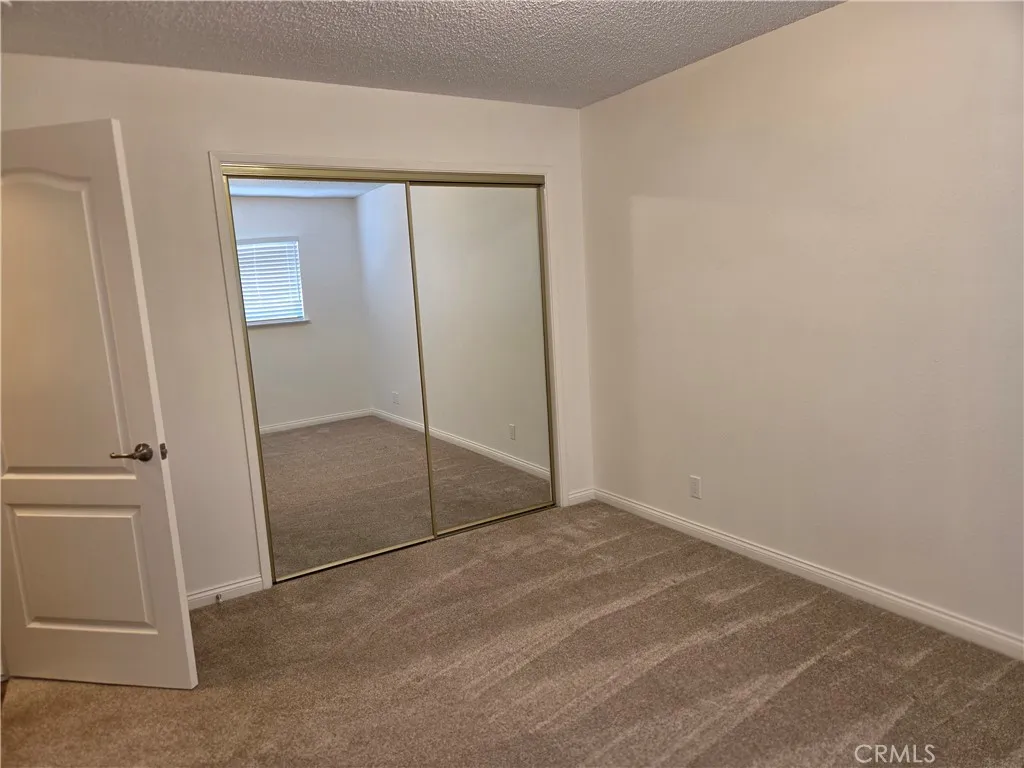 2nd bedroom off hallway with sliding glass doors