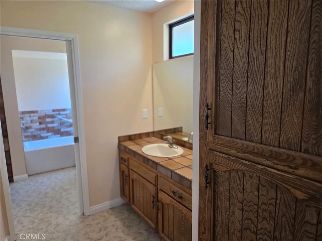 Two separate sinks with cabinet storage between them