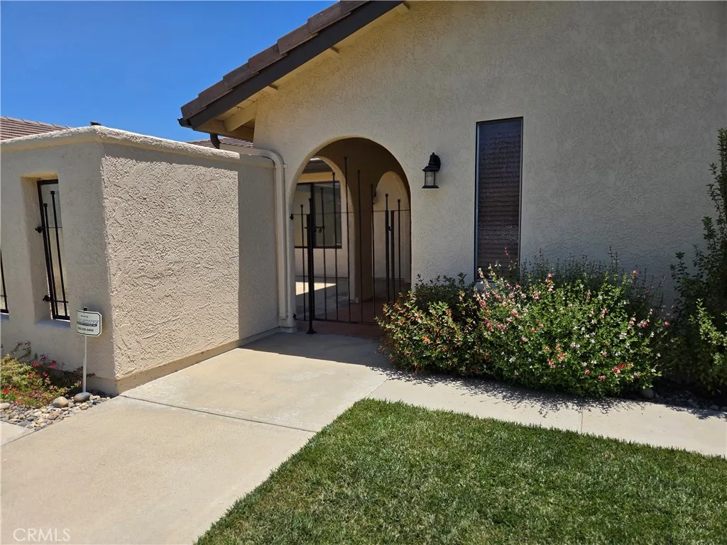 Front entry gate to door and adjoining private large patio