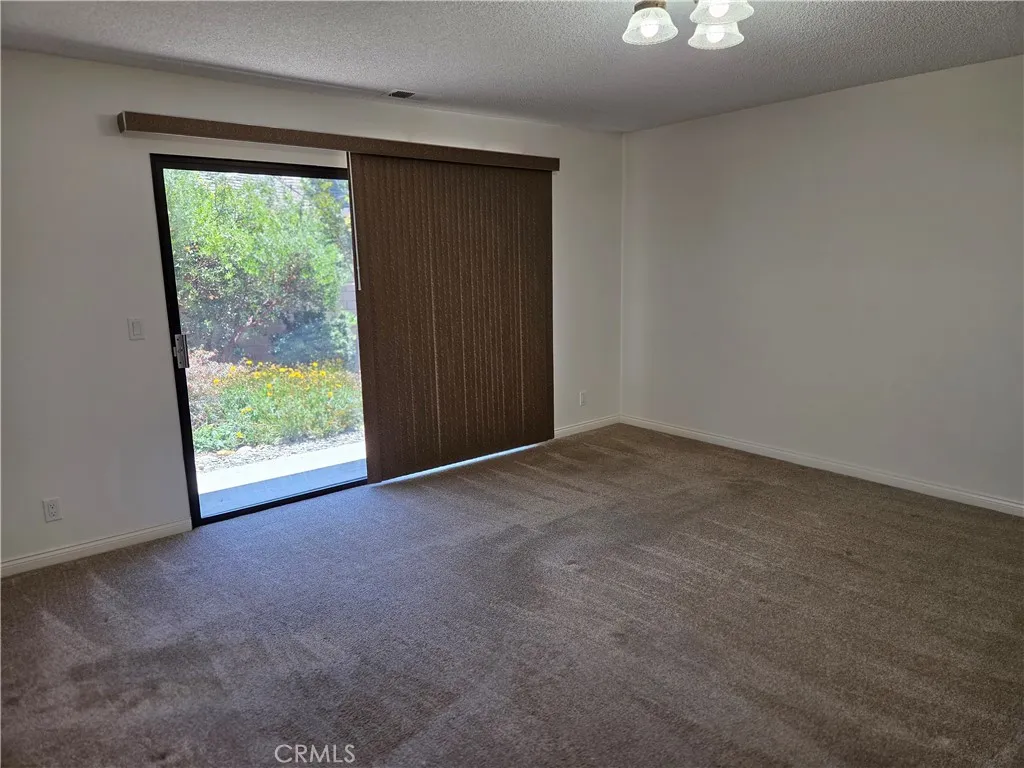 Primary bedroom with sliding doors to rear yard