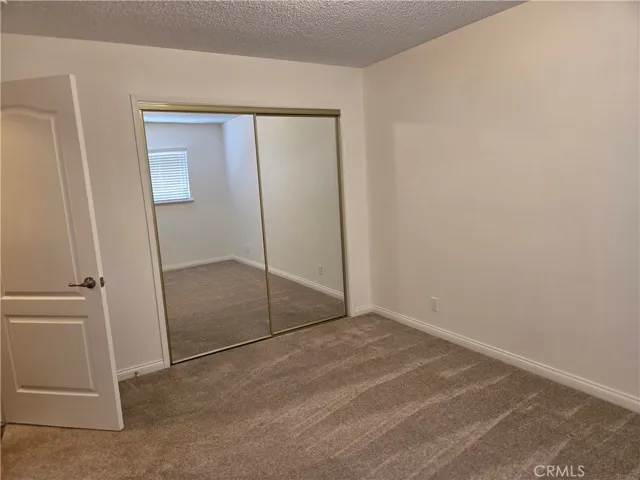2nd bedroom off hallway with sliding glass doors