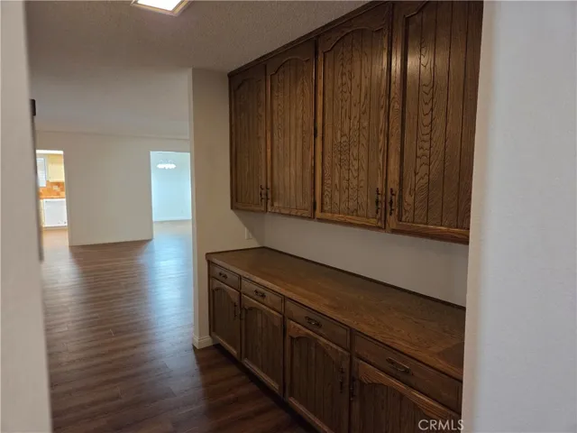 Hallway leading to family room with a lot of cabinets