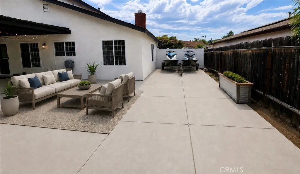 Digitally Altered - Jetskiis and Patio furniture added to image.  Modifications to fence and frontyard block wall required to accomodate trailer parking