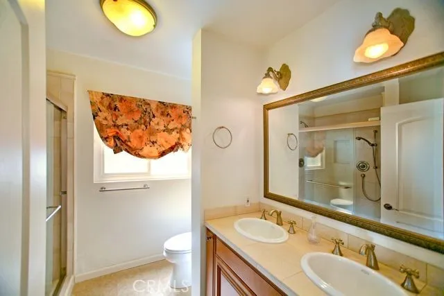 Primary ensuite bath with His and Hers sinks, and walk-in shower with dual showerheads.