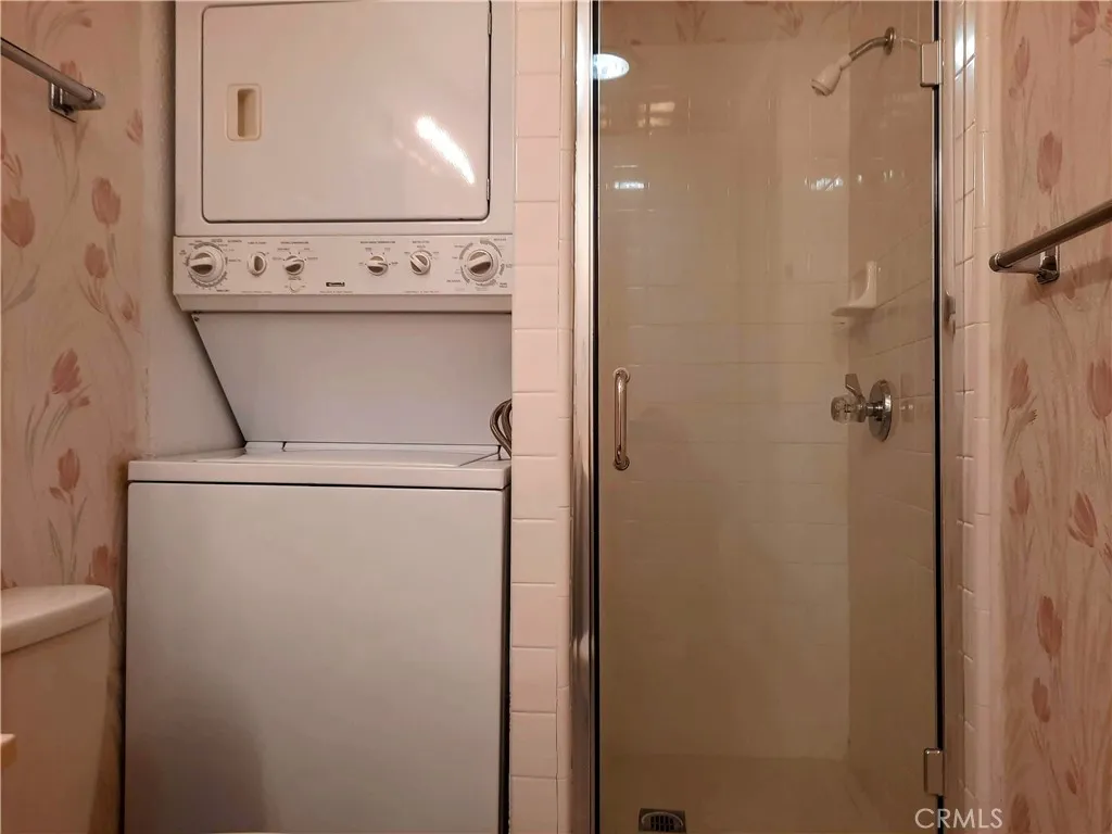 Bathroom w/ walk-in shower and stacked washer & dryer Bathroom w/ walk-in shower and stacked washer & dryer