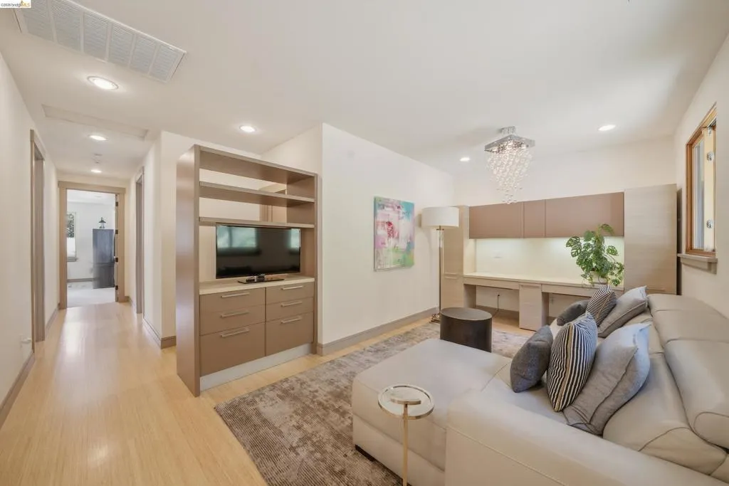 Living area featuring wood-finish flooring and recessed lighting