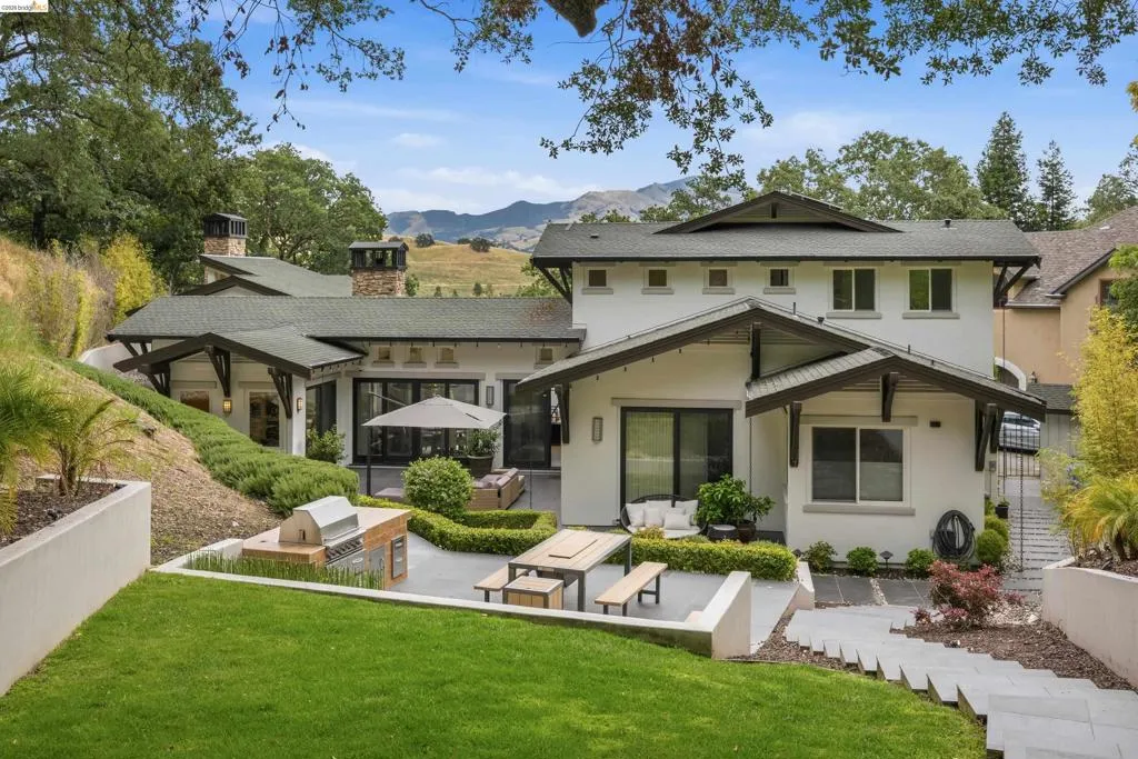 Rear exterior featuring multiple outdoor living areas