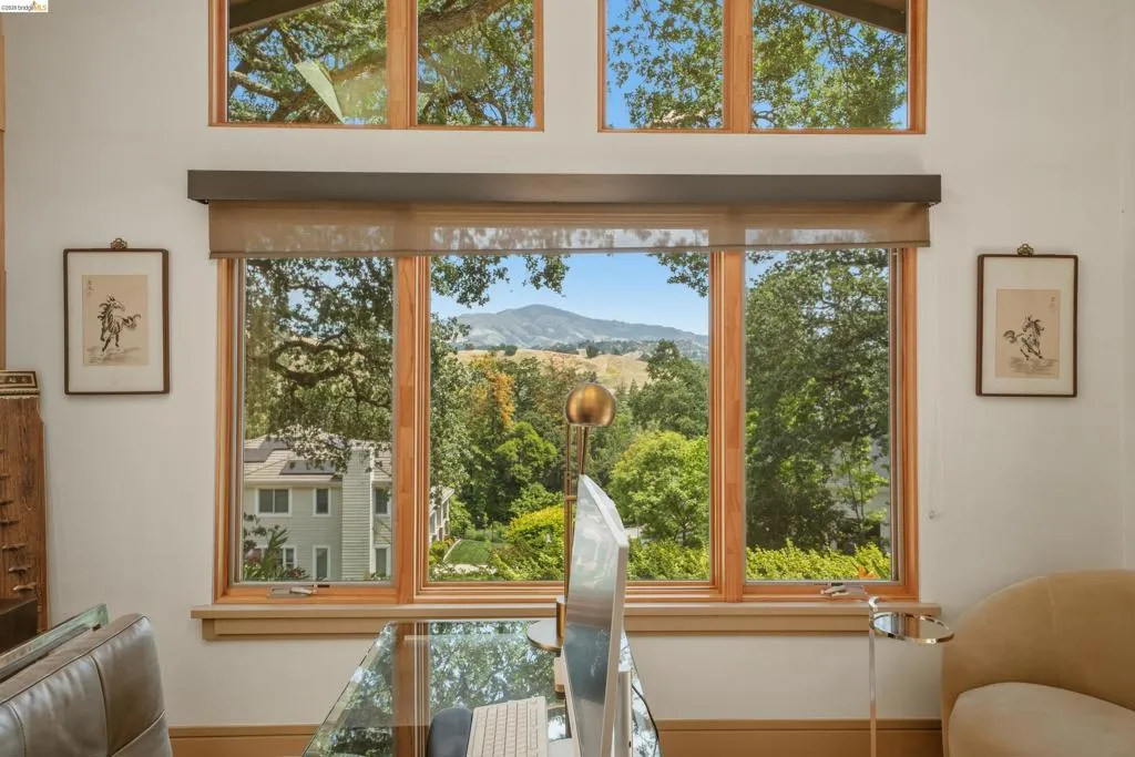 Triple-pane window assembly with natural wood frames, offering expansive outdoor scenery
