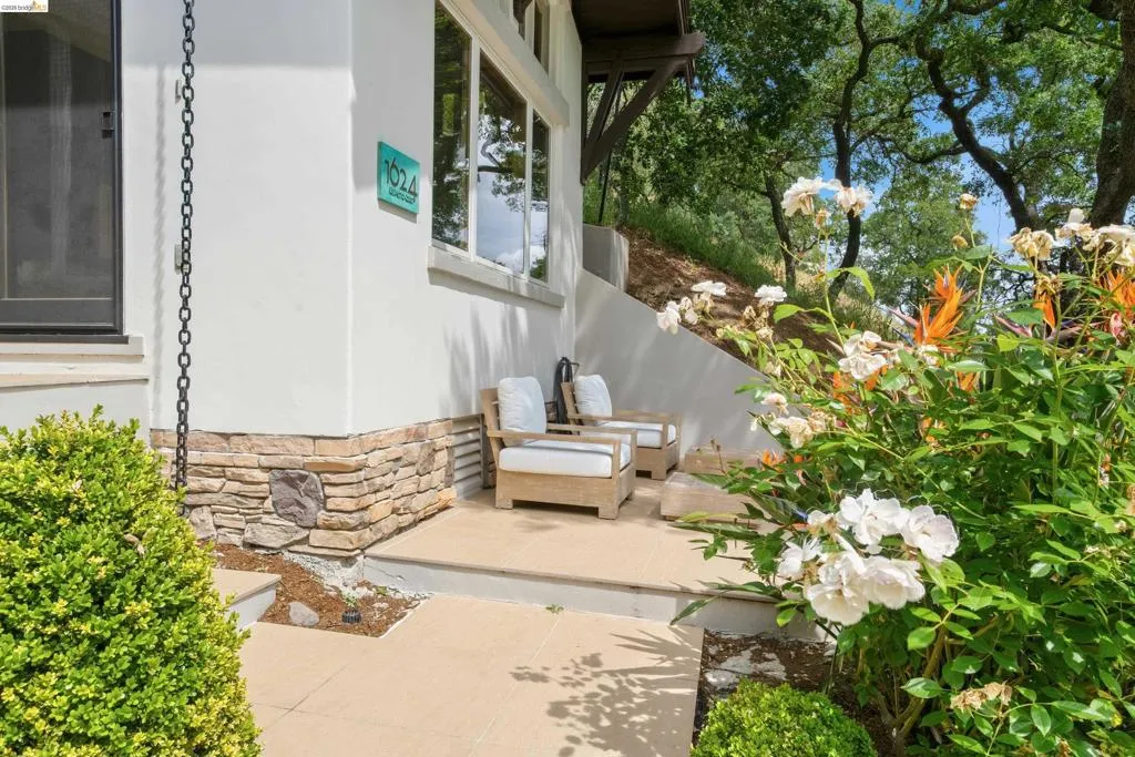 Exterior patio area featuring a stucco facade with stone veneer accents