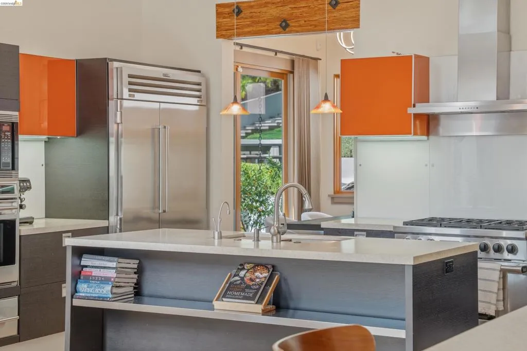 Gourmet kitchen with a large central island featuring an undermount sink and gooseneck faucet