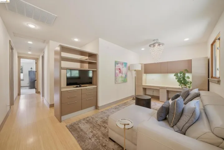 Living area featuring wood-finish flooring and recessed lighting