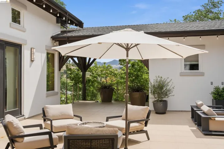 Expansive outdoor patio with light-toned tile flooring