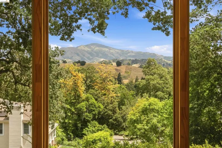 Wood-framed window showcasing expansive natural scenery