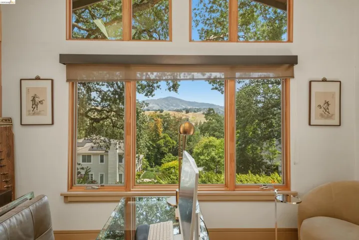 Triple-pane window assembly with natural wood frames, offering expansive outdoor scenery