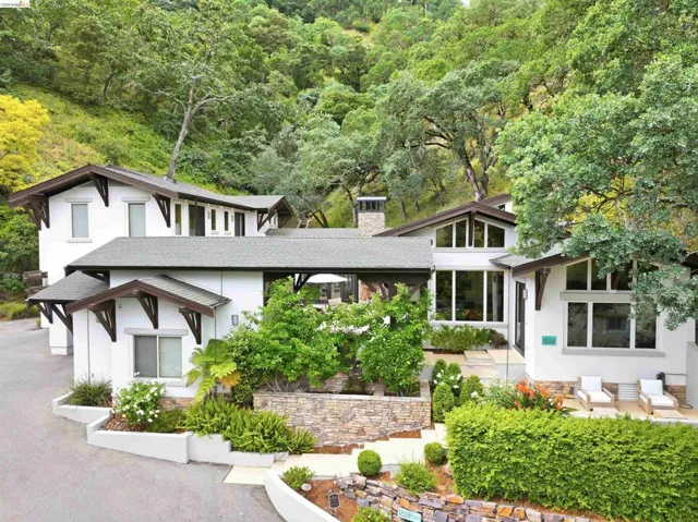 Contemporary white stucco exterior with multiple rooflines and dark trim accents