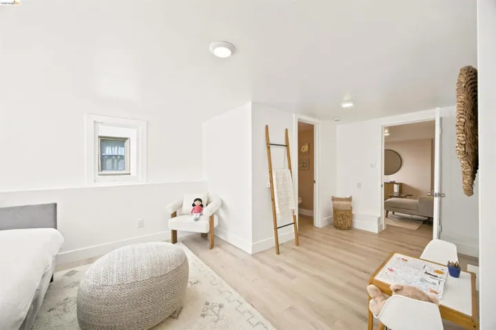 Light wood-finish flooring complements white walls and recessed lighting