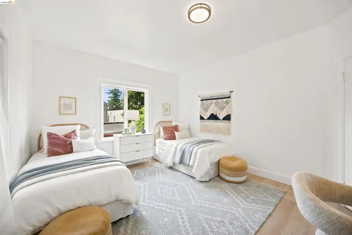 Bright room featuring light wood-finish flooring and a white color palette