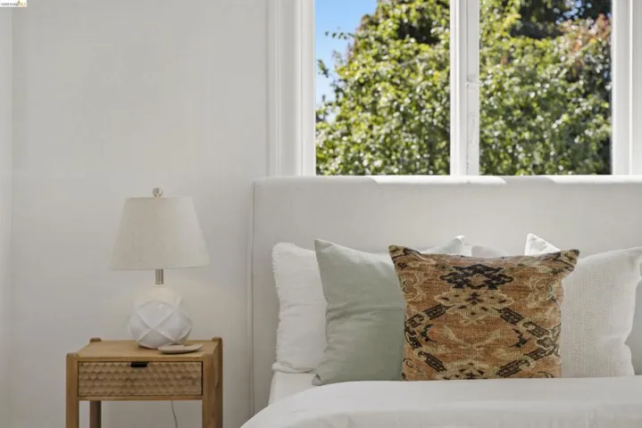 Double-hung windows with exterior foliage framing light-filled interiors