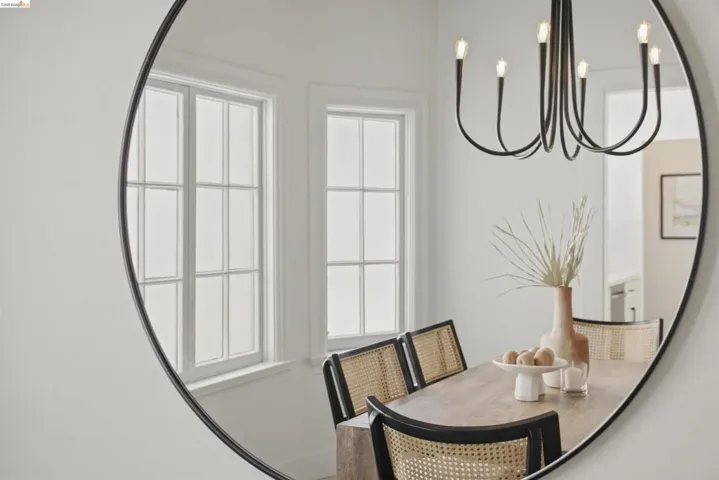 Dining area featuring a contemporary black chandelier and a rectangular wood-finish dining table