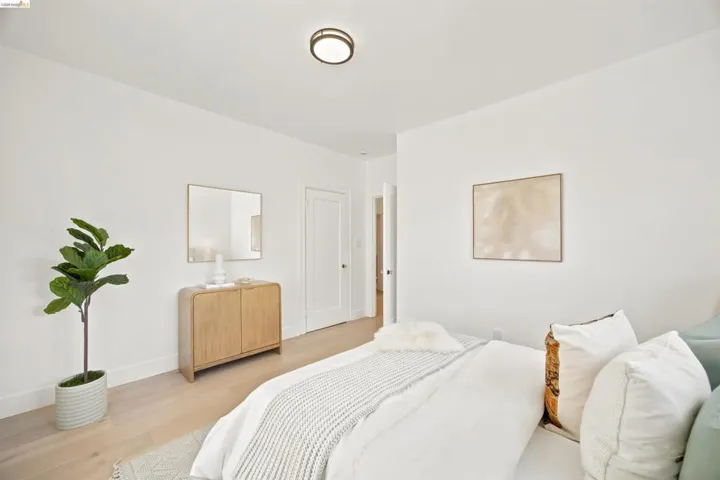 Light wood-finish flooring complements crisp white walls