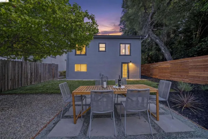 Rear facade featuring a private outdoor area with a wood-slat fence