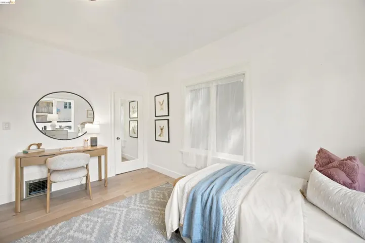 Light wood-finish flooring complements the bright white walls of this space