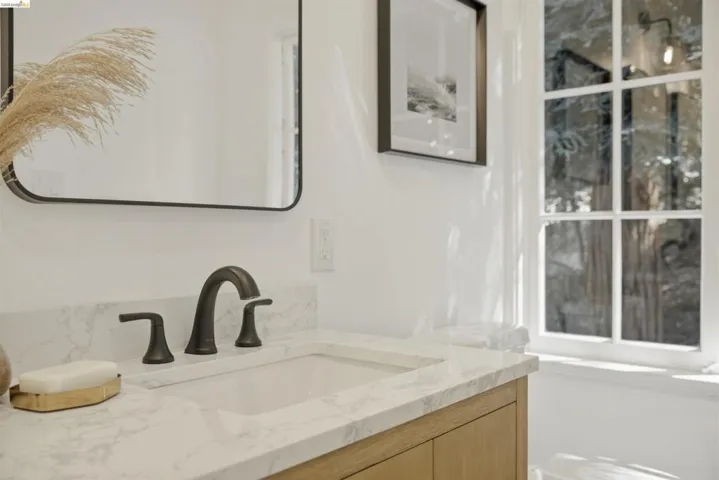 Vanity featuring a built-in rectangular sink, stone countertop, and oil-rubbed bronze faucet