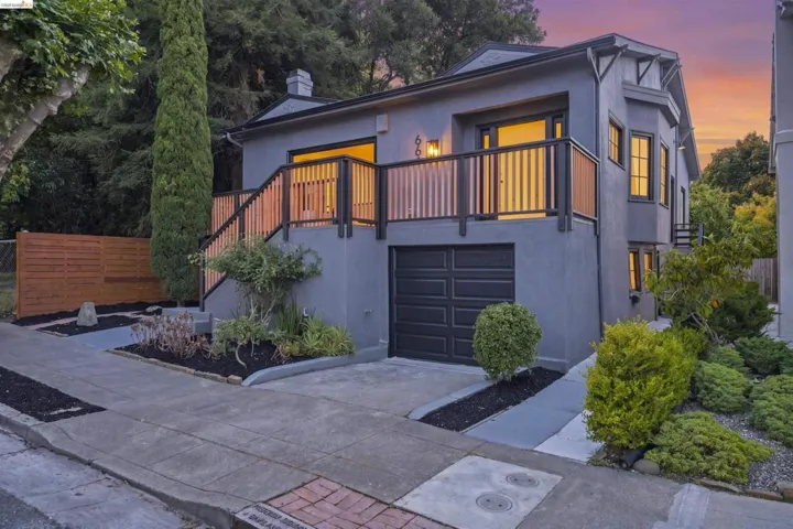 Stucco exterior with a prominent balcony featuring wood and dark-toned railings